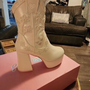 White boots with stitching with pink bottoms